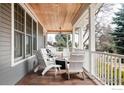 Relaxing porch with wood deck, featuring stylish seating and an outdoor fireplace at 521 Hawthorn Ave, Boulder, CO 80304