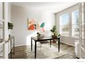 Bright home office featuring modern desk, stylish decor, and lots of natural light from a large window at 6041 N Orleans St, Aurora, CO 80019