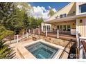 The backyard features a stone-trimmed hot tub and a multilevel deck perfect for entertaining and relaxing at 700 Linden Ave, Boulder, CO 80304