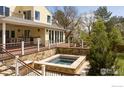 The backyard features a beautiful stone hot tub and a multilevel deck perfect for entertaining at 700 Linden Ave, Boulder, CO 80304