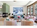 Bright living room featuring a modern fireplace, mountain artwork, and comfortable seating at 7076 Indian Peaks Trl, Boulder, CO 80301