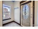 Entryway with a beautiful decorative glass door, tiled floor, and a coat rack for convenience at 820 Kimbark St # B, Longmont, CO 80501