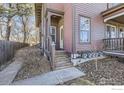 Charming front porch with detailed woodwork and a view of the well-maintained landscaping at 820 Kimbark St # B, Longmont, CO 80501