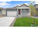 Well-maintained home showcasing a front porch, manicured lawn, and a two-car garage at 862 Crest St, Lochbuie, CO 80603