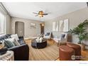 Inviting living room with a ceiling fan, stylish furniture, and natural light at 971 Oak Pl, Thornton, CO 80229