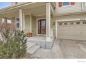 Welcoming front porch leads to a well-maintained home with a convenient two-car garage at 1157 Mircos St, Erie, CO 80516