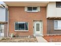 Attractive brick townhome with a tidy yard, showcasing a cozy and inviting exterior at 1187 Milky Way, Thornton, CO 80260