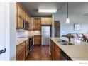 Well-equipped kitchen featuring stainless steel appliances and wood cabinets at 1379 Charles Dr # E5, Longmont, CO 80503