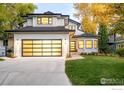 Contemporary home featuring a spacious driveway, modern garage door, and a well-manicured lawn at 1385 Kalmia Ave, Boulder, CO 80304