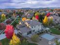 Stunning aerial view of the home showcasing its manicured backyard, basketball court, and landscaping at 13878 Barbour St, Broomfield, CO 80023