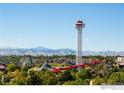 An aerial view of an amusement park with mountains in the distance at 1401 Wewatta St # 714, Denver, CO 80202