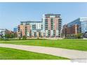 A full exterior shot of the apartment complex with a well-manicured lawn at 1401 Wewatta St # 714, Denver, CO 80202