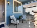 Inviting front porch area furnished with comfortable seating, perfect for relaxing and enjoying the outdoors at 1417 Bluemoon Dr, Longmont, CO 80504