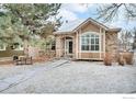 Charming single-story home featuring a stone facade, manicured front lawn, and inviting entrance at 1629 Metropolitan Dr, Longmont, CO 80504