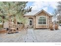 Charming home featuring a stone facade, manicured front lawn, and inviting entrance at 1629 Metropolitan Dr, Longmont, CO 80504