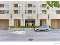 Welcoming entrance to Glass House featuring elegant architectural details and manicured greenery at 1700 Bassett St # 1303, Denver, CO 80202