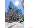 Striking exterior view of the building featuring glass accents and well-maintained landscaping at 1700 Bassett St # 1303, Denver, CO 80202