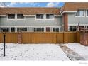 Charming home featuring a fenced yard and walkway, showcasing a well-maintained exterior on a snowy day at 2016 W 101St Ave, Thornton, CO 80260