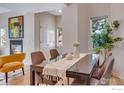 Elegant dining room with a fireplace and a neutral color palette at 2256 Watersong Cir, Longmont, CO 80504