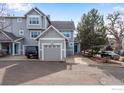 Charming townhome featuring a spacious two-car garage with a driveway and attractive curb appeal at 2256 Watersong Cir, Longmont, CO 80504