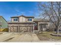 Charming two-story home with stone accents, a three-car garage, and a well-maintained front yard at 270 Terra Vista St, Brighton, CO 80601