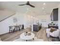 Inviting living area and kitchen featuring modern furnishings, a kitchen island with barstools, and stylish decor at 2723 Bear Springs, Longmont, CO 80503