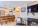 Bright living room featuring a view to the modern kitchen and a cozy fireplace at 3025 Broadway St # 18, Boulder, CO 80304