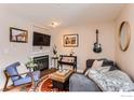 Cozy living room featuring a fireplace, guitar decor, and stylish furnishings at 3025 Broadway St # 18, Boulder, CO 80304