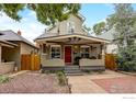 Attractive two-story home with a covered front porch and nicely landscaped front yard at 3440 W 33Rd Ave, Denver, CO 80211