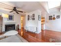 A white-walled living room featuring a fireplace, hardwood floors, and modern decor and fixtures at 3630 Iris Ave # D, Boulder, CO 80301