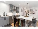 Cozy kitchen features gray cabinetry, white subway tile, and a large center island at 3755 Birchwood Dr # 45, Boulder, CO 80304