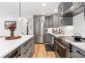 Well-lit kitchen with gray cabinets, stainless steel appliances, and white subway tile backsplash at 3755 Birchwood Dr # 45, Boulder, CO 80304