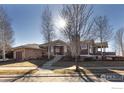 Attractive single Gathering home with charming stone accents, mature trees and manicured front yard at 3805 Glenn Eyre Dr, Longmont, CO 80503