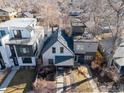 Aerial view of a home with a blue roof nestled among mature trees at 4464 N Raleigh St, Denver, CO 80212