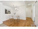 Well-lit dining room with modern table, chairs, wood floors and contemporary lighting at 4500 Baseline Rd # 3105, Boulder, CO 80303