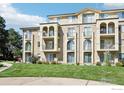 Low-rise apartment building with balconies, lush green lawn, and stucco facade at 4500 Baseline Rd # 3105, Boulder, CO 80303