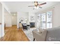 Cozy living room with fireplace, wood floors, and a sliding door to the balcony at 4500 Baseline Rd # 3105, Boulder, CO 80303