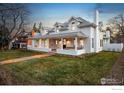 Charming two-story home featuring a welcoming front porch, manicured lawn, and classic architectural details at 502 Highland Ave, Boulder, CO 80302