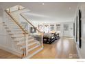 Bright, open interior showcasing a staircase, light wood floors, and living area with large windows at 502 Highland Ave, Boulder, CO 80302