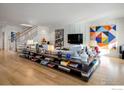 Spacious living room with hardwood floors, custom shelving, and a modern, comfortable design at 502 Highland Ave, Boulder, CO 80302