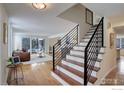 Modern staircase with sleek metal railings leading to the upper level and open living space at 7240 Clubhouse Rd, Boulder, CO 80301