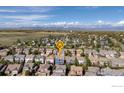 Gorgeous aerial view of a neighborhood near the mountains, with lush greenery and stunning mountain views at 739 Graham Cir, Erie, CO 80516
