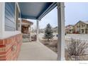 Inviting front porch with white pillars and a view of the neighborhood at 739 Graham Cir, Erie, CO 80516