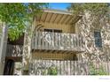 Exterior balcony featuring a wooden rail and shaded outdoor area at 8050 Niwot Rd # 58, Niwot, CO 80503