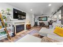 Spacious living room with a fireplace, television, and open layout flowing into the dining area at 8050 Niwot Rd # 58, Niwot, CO 80503