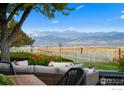 Scenic backyard with patio seating, white picket fence and mountain views at 1017 Azure Way, Louisville, CO 80027