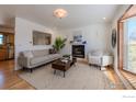 Bright living room featuring a cozy fireplace, and a large window that offers plenty of natural light at 1135 Fern St, Broomfield, CO 80020