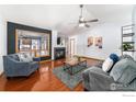 Inviting living room featuring a cozy fireplace, vaulted ceilings, and stylish decor with hardwood flooring at 1170 Jefferson Dr, Berthoud, CO 80513