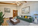 Inviting living room featuring a comfortable green sofa and stylish decor at 1507 Atwood St, Longmont, CO 80501