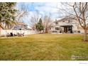 Expansive backyard featuring a patio area, outdoor seating, and a well-maintained lawn at 1575 Kalmia Ave, Boulder, CO 80304